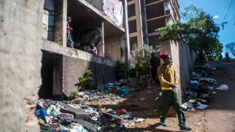 BBC/SHIRAAZ MOHAMED An unidentified man is seen leaving the San Jose the derelict San Jose building in Johannesburg, South Africa