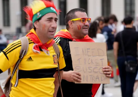 Andrew Milligan/PA Media Spanish fan holds sign asking for a ticket to the game