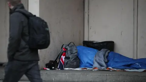 A rough sleeper in a doorway