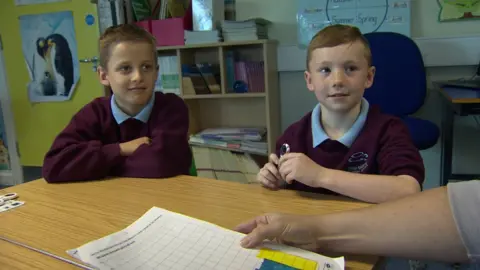 Zach (right) says the toys could improve handwriting skills
