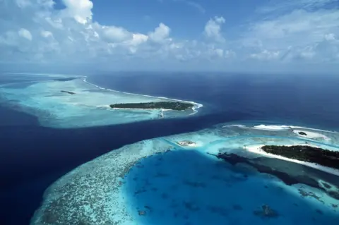 Science Photo Library Coral islands in Maldives