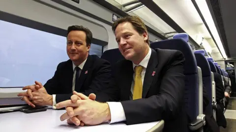 Getty Images Britain's Prime Minister David Cameron (L) and Deputy Prime Minister Nick Clegg ride a train to a cabinet meeting at the 2012 Olympic Games site on January 9, 2012 in London, England.