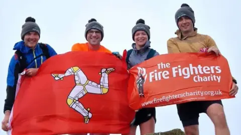 ISLE OF MAN FIRE AND RESCUE The team of fundraisers at the top of Scafell Pike