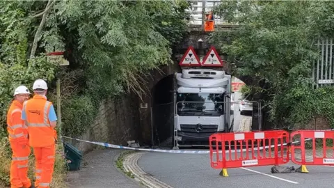 BBC Lorry stuck under bridge