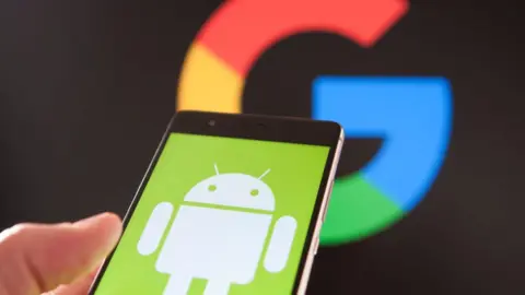 Getty Images A smartphone showing the Android logo, held in front of a Google logo