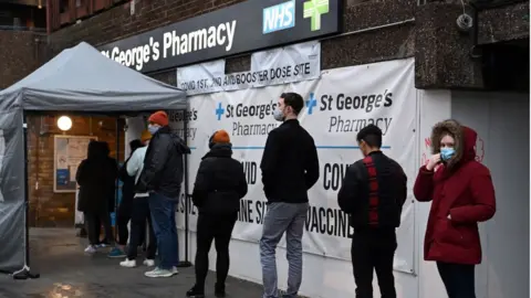 EPA People queuing for booster jabs outside pharmacy