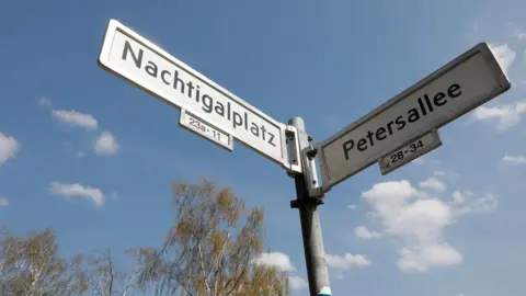AFP View taken on April 12, 2018 shows the plates with the street names "Petersallee" and "Nachtigalplatz" in the so-called African Quarter in the northwest of Berlin.