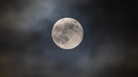 Sammy/WeatherWatchers The moon against a cloudy sky. 