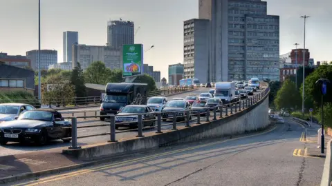 Mancunian Way in Manchester is busy with traffic. 