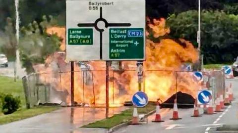 A road sign showing a fire explosion