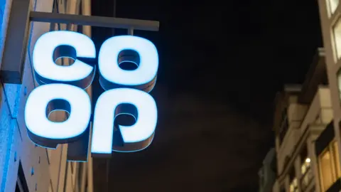 Co-op sign lit up at night in London