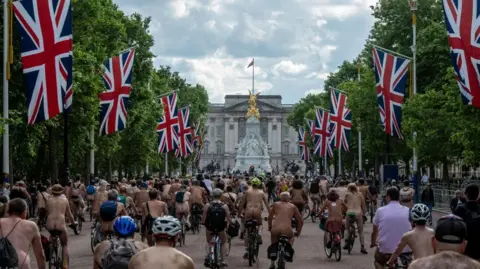 Reuters Naked cyclists make their way up The Mall in London.