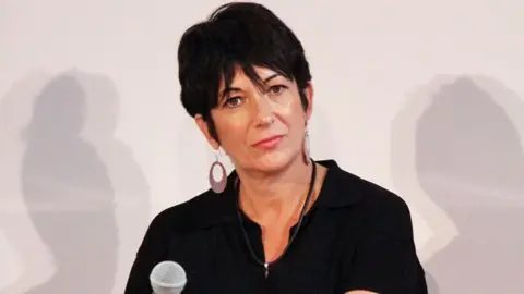 Getty Images is a picture of Ghislaine Maxwell from the 2013. She wears a black dress with earrings, and she wears a black haircut.