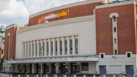 Getty Images A photo of the outside of a music venue, an early 20th century building with Art Deco design. 
