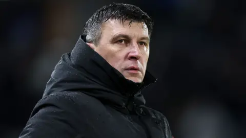 Hull City boss Sergej Jakirovic watches on from the sidelines in a black coat