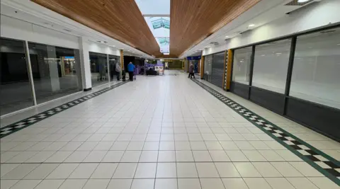 Pacemaker Inside of Connswater Shopping Centre, showing floor tiles and windows