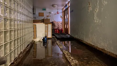 BBC flood waters can be seen inside a former QMC Clinic