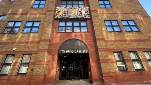 Julita Waleskiewicz /BBC St Albans Crown Court: A brown-and-red-brick building with the words "crown court" written above the entrance in silver capital letters