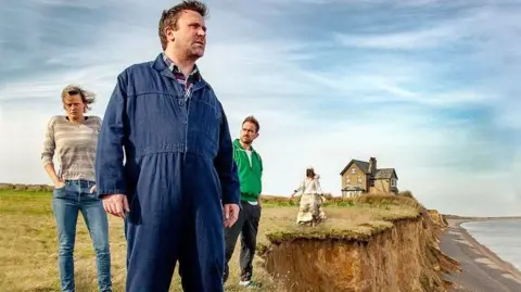 Four people gathered on the edge of a crumbling cliff