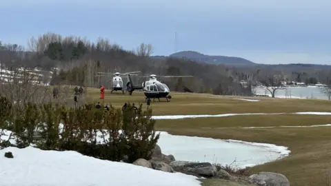 Ontario Provincial Police Helicopters seen landing people at a golf course along the water