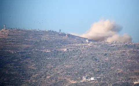 Smoke rises above the occupied West Bank