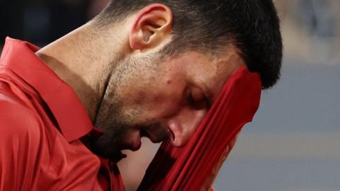 Novak Djokovic wipes his brow at the French Open