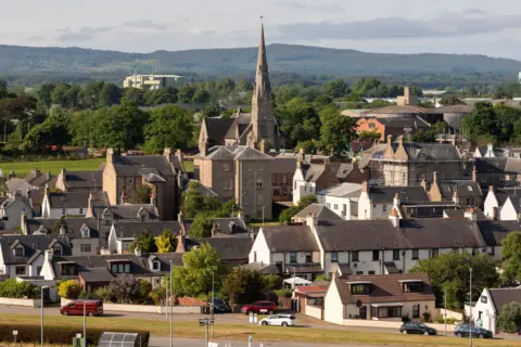 Getty Images A view of Invergordon in the Highlands showing houses and church with a steeple.