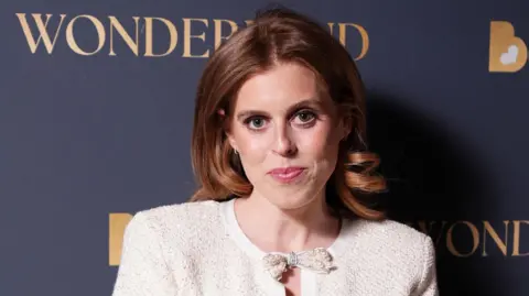 Princess Beatrice smiles at the camera as she attends Borne's Wonderland event at the V&A in London