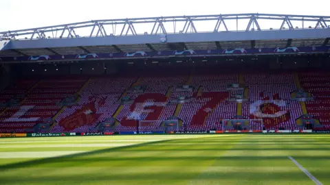 PA Media Pemandangan bagian dalam stadion Anfield yang kosong melihat ke seberang lapangan 