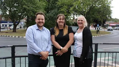 LDRS Councillors Jack Haines, Maria Coward and Alison Collinson standing by a roundabout near the roadworks

