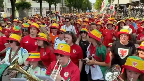 Wales fans marching in the streets and playing instruments