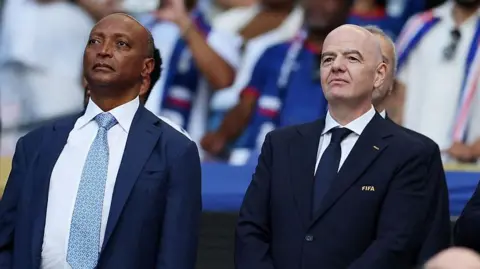 President of the Confederation of African Football Patrice Motsepe and FIFA President Gianni Infantino are seen ahead of the 2026 World Cup Group H football match between Uruguay and Cape Verde at the Miami Stadium in Miami Gardens on June 21, 2026.