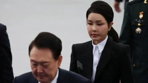 Reuters South Korean President Yoon Suk Yeol and his wife Kim Keon Hee arrive for a celebration to mark 76th anniversary of Korea Armed Forces Day, in Seongnam, South Korea, on 1 October 2024