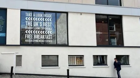 A sign in a window of a block of student flats in Exeter