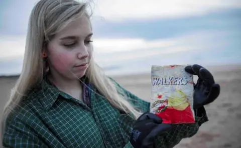 Beach Guardian Emily Stevenson with the crisp packet she found