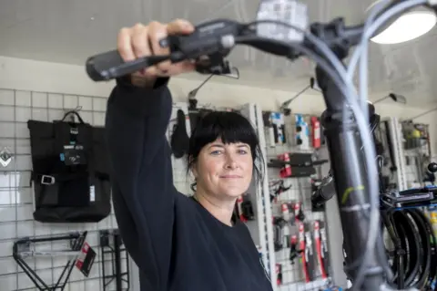 Alison Baskerville Roz McGuigan in a bike shop