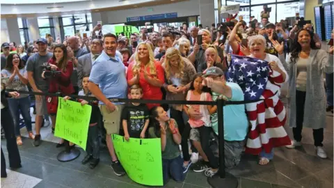 Getty Images Crowd waiting for Mr Holt and Mrs Caleno