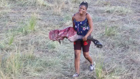 Serondela Lodge Woman holding buffalo leg
