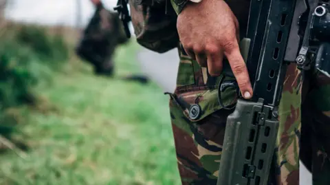 Close up of a solider holding a gun