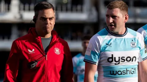 Johann van Graan (left) and Finn Russell (middle) at half-time of a Challenge Cup match this season
