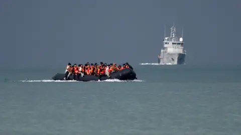 Reuters Migrants on an inflatable dinghy attempt to cross the English Channel to reach the UK.