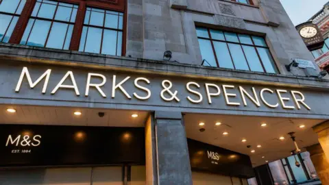 Shop front that reads Marks & Spencer. Street sign reads Oxford Street.