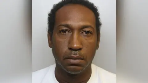 Avon and Somerset Police Mugshot of Woolley. He is wearing a white shirt.