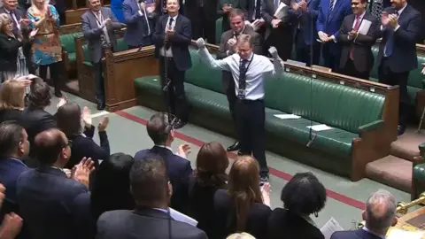 PA Media Craig Mackinlay receiving a standing ovation in the House of Commons