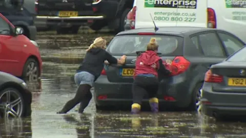 BBC cars stuck in rain water and mud at Festival no.6