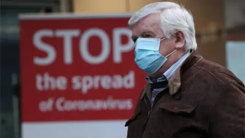 PA Media man walking in glasgow
