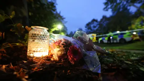 Reuters Flowers near police search at Loxbeare Drive in Furzton, Milton Keynes