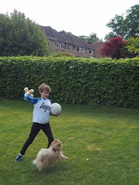 BBC William playing in his garden with Teddy