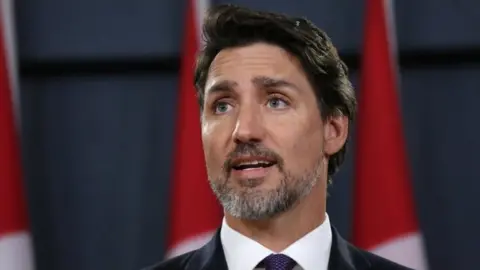 AFP/Getty Images Canadian Prime Minister Justin Trudeau speaks at a news conference in Ottawa. Photo: 9 January 2020