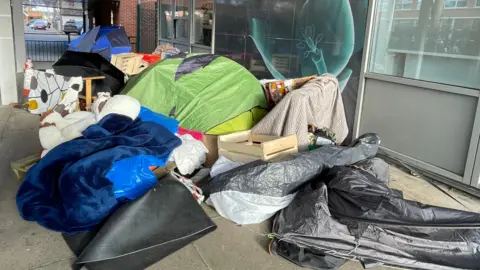 BBC Pile of blankets, tents, plastic sheeting and mats